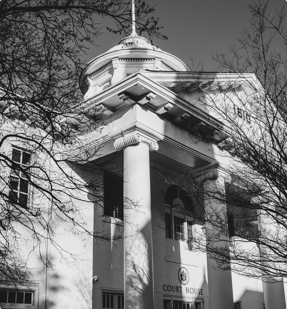 Grand neoclassical courthouse exterior with white columns and pediment, symbolizing legal authority and litigation excellence.